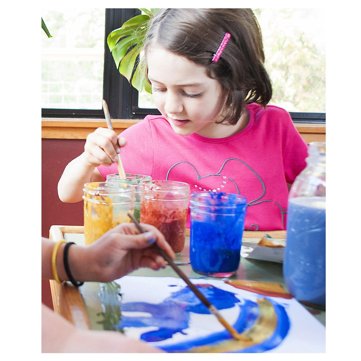 Two children painting with Natural Earth Paint