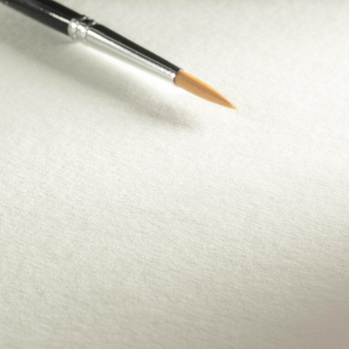 A sheet of bamboo watercolor paper close up with paint brush