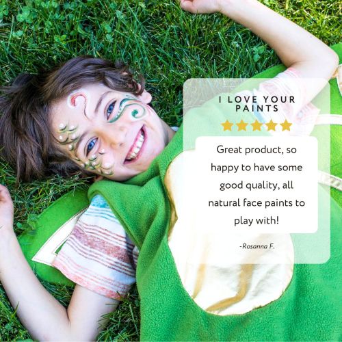 written review and photo of face painted child laying in grass