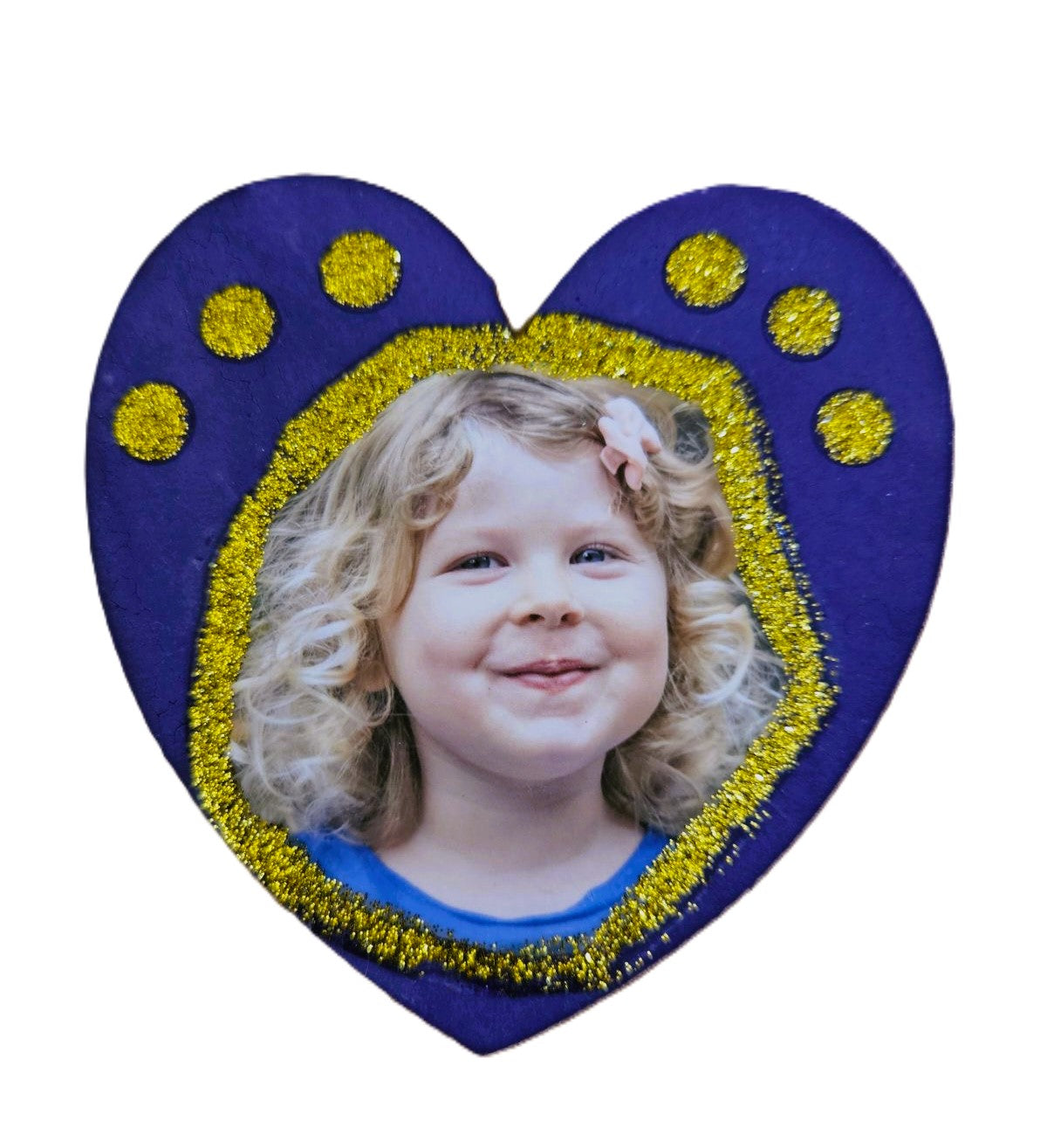 photo of child on painted wooden heart