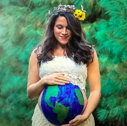Young pregnant woman with a painted belly
