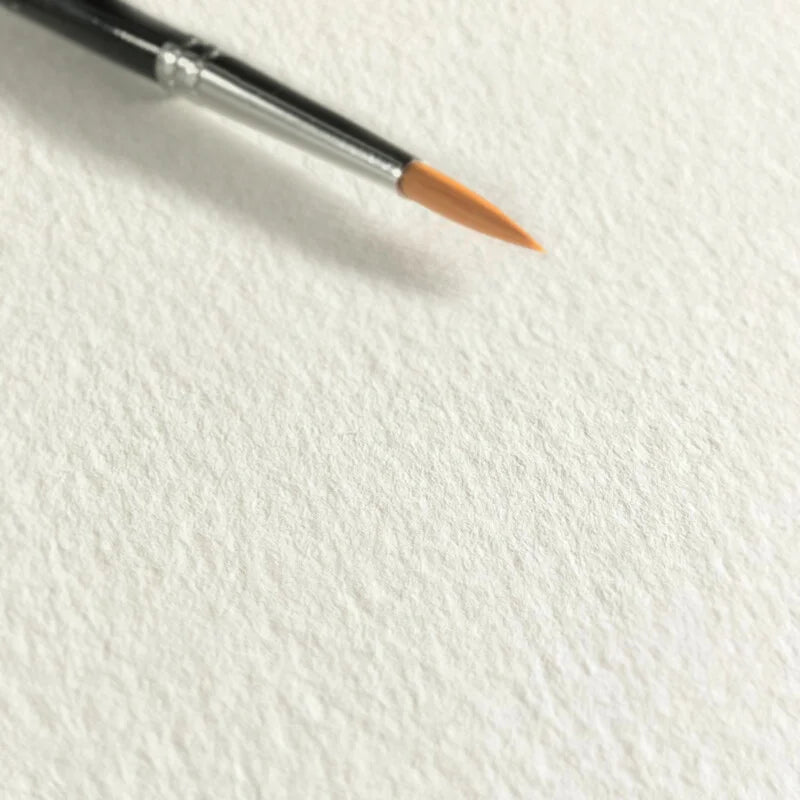 Close-up of the sugar cane watercolor paper highlighting the texture  with a fine art paint brush tip for size